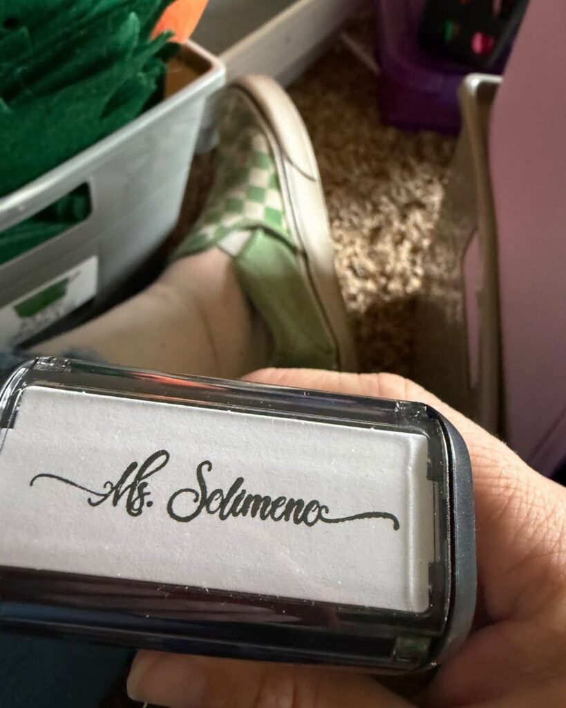 Personalized rubber stamp showing the name Ms. Solimeno in black cursive script.
