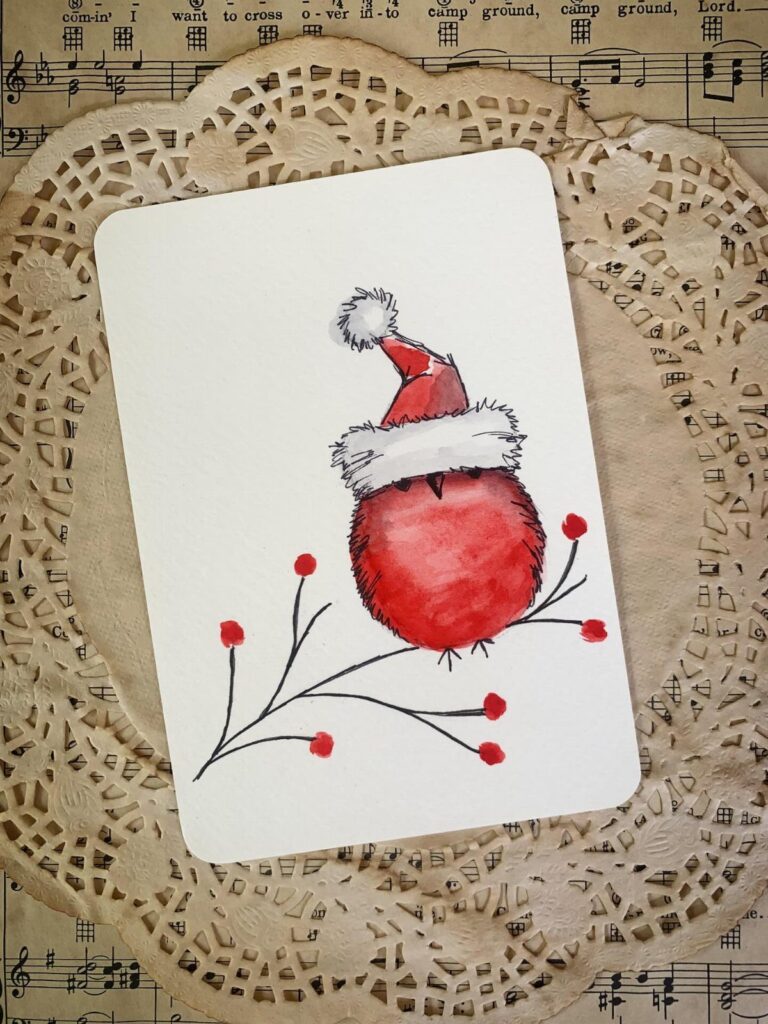 Watercolor Christmas card with a red character in a Santa hat on lace doily